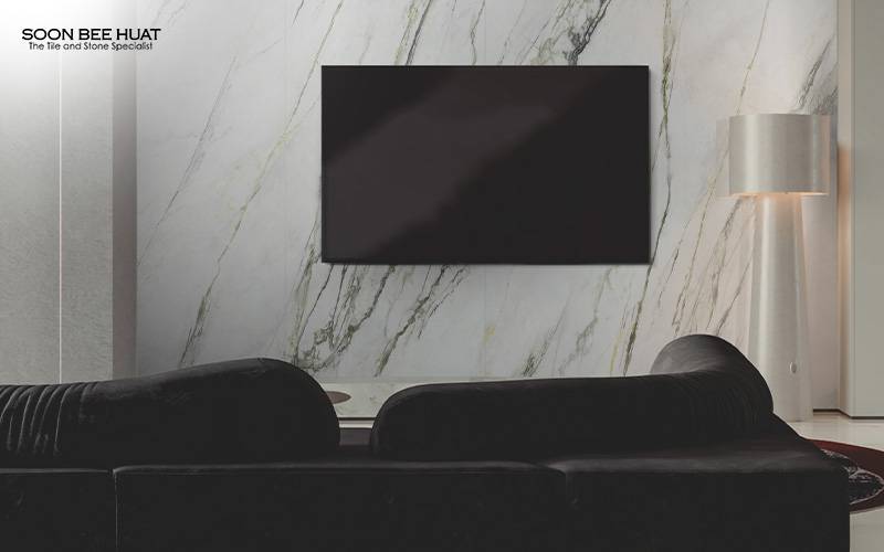 Living room featuring an elegant marble-look large format tile feature wall.